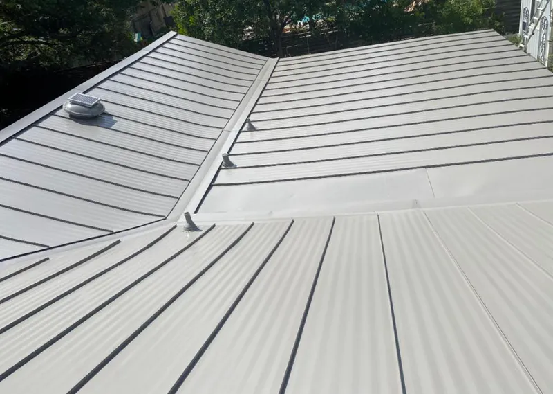 Solar attic fan installed on a metal roof for Roof Ventilation in Bentonville